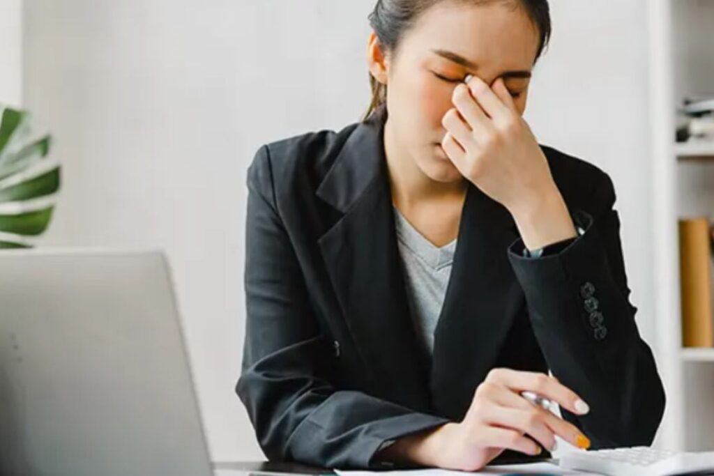 stressed out lady sitting at a desk