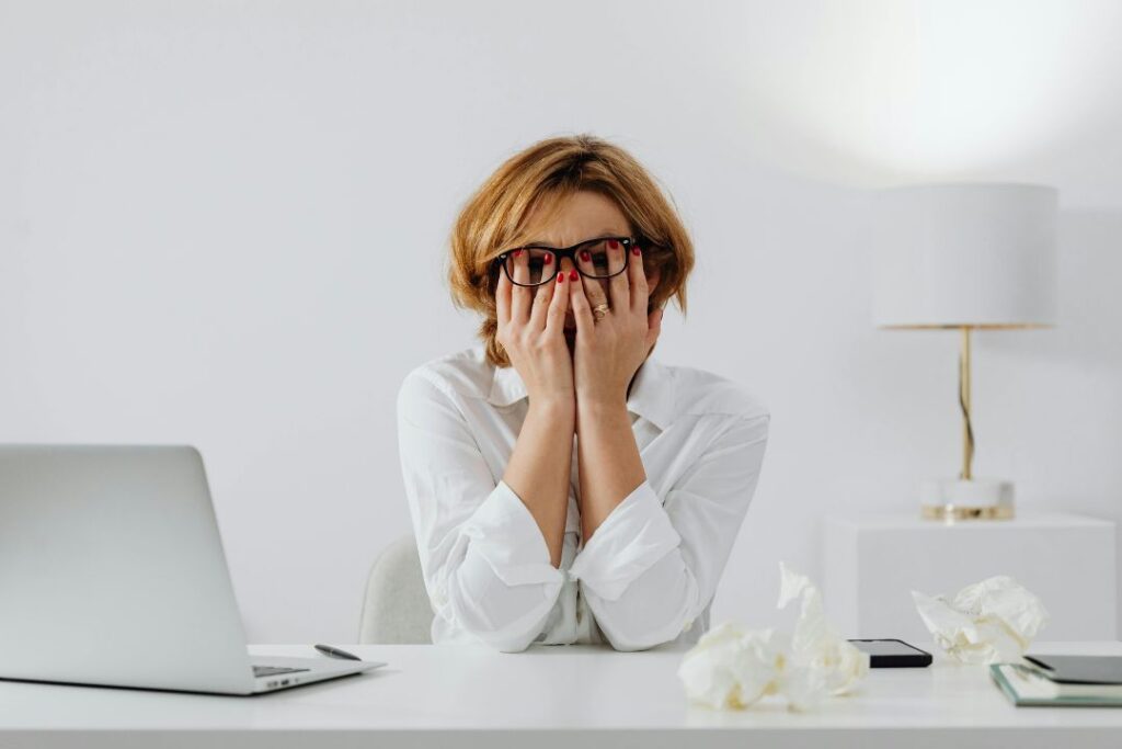 a woman with chronic stress sitting at her desk