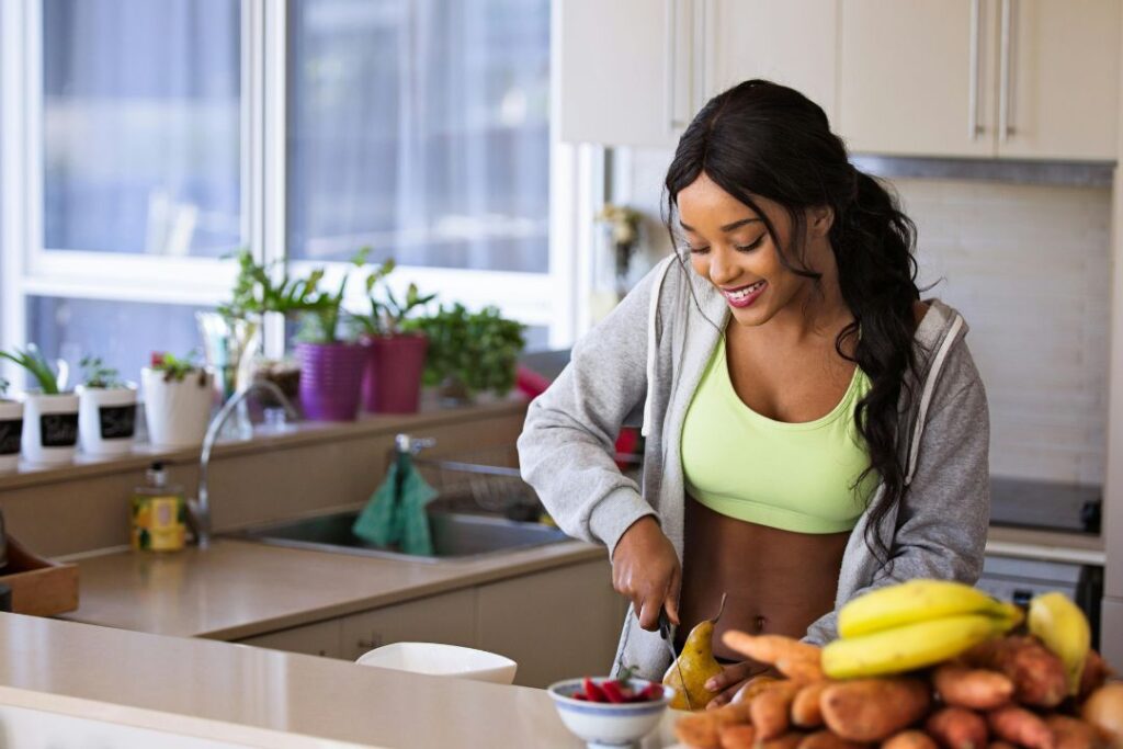 a young woman preparing fruit in the kitchen