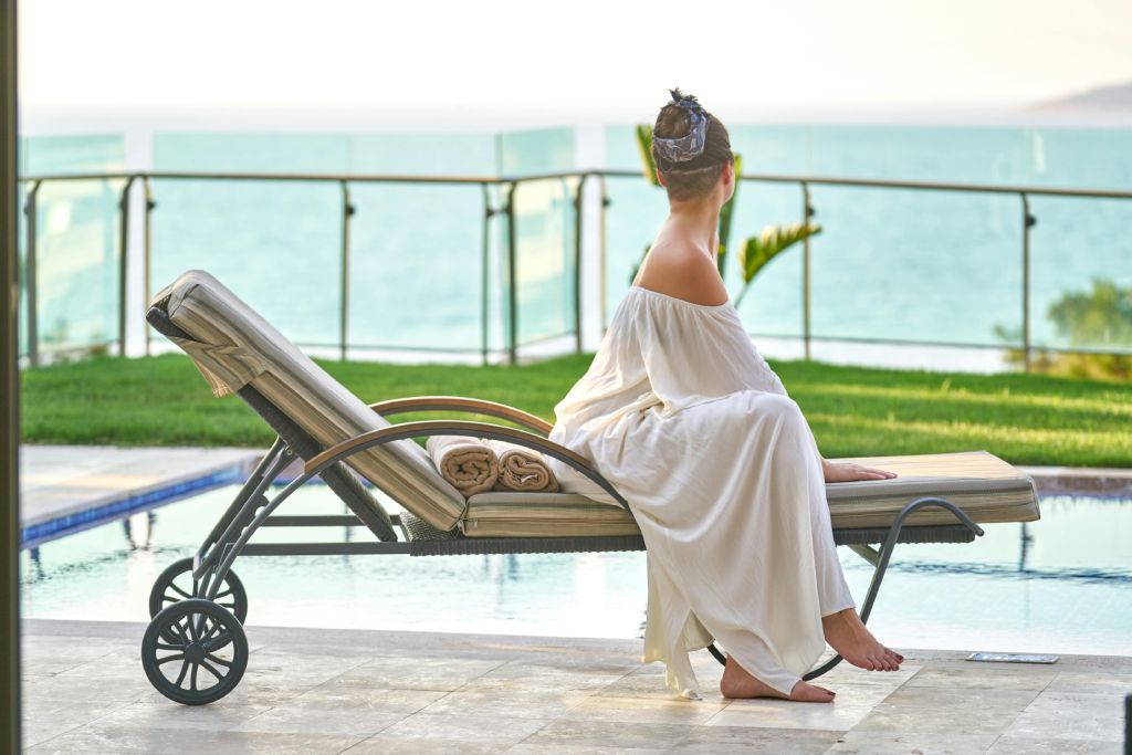 a woman sitting looking out to see in a luxury spa hotel