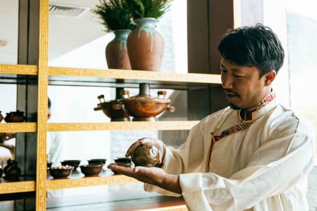 a tibetan healer showing different types of Tibetan plants and remedies