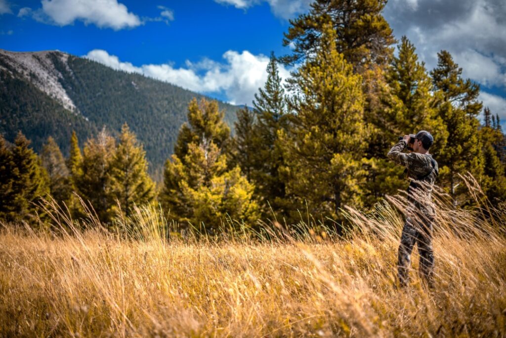 a man wildlife watching from afar